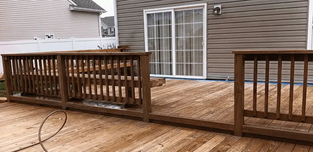 Deck sealing service protecting a backyard wood deck and railings in Nashua, NH