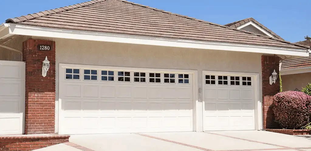Residential garage door repair service for a double garage door in Nashua, NH