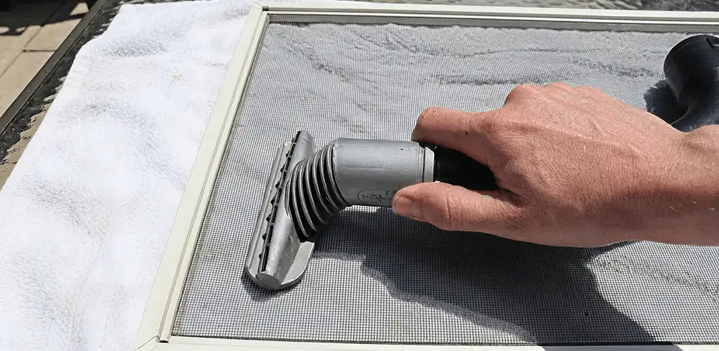 Window screen repair cleaning and fixing a damaged screen mesh in Nashua, NH