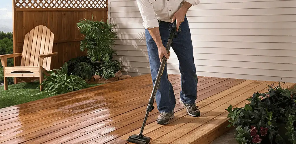 Deck staining service applying stain to a backyard wood deck in Nashua, NH